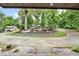 View of the circular driveway with mature landscaping from the covered front porch at 3270 Brookview Dr, Marietta, GA 30068