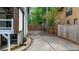 Concrete driveway with a wooden fence and gate, offering secure backyard access at 3270 Brookview Dr, Marietta, GA 30068