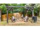 Relaxing backyard firepit area with chairs, hanging swing chairs, and decorative lighting at 3270 Brookview Dr, Marietta, GA 30068