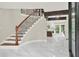 Light-filled foyer showcasing a staircase with iron railings, complemented by marble floors and modern finishes at 3270 Brookview Dr, Marietta, GA 30068