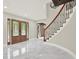 Bright foyer featuring marble floors, a staircase with iron railings, and a view of the elegant front doors at 3270 Brookview Dr, Marietta, GA 30068