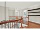 Second floor hallway with hardwood floors, open staircase, and lots of natural light at 3270 Brookview Dr, Marietta, GA 30068