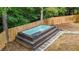 Backyard swim spa with surrounding platform and walkway, set against a wooded backdrop at 3270 Brookview Dr, Marietta, GA 30068