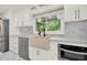 Modern kitchen with white cabinets, stainless appliances, marble countertops, and stainless sink at 3270 Brookview Dr, Marietta, GA 30068