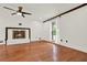 Bright living room with a fireplace, wood floors, and a ceiling fan at 3270 Brookview Dr, Marietta, GA 30068
