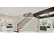 Elegant staircase with wooden steps and wrought iron spindles, complemented by modern lighting and open layout at 3270 Brookview Dr, Marietta, GA 30068