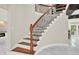 Elegant staircase featuring wood treads, iron railings, and ample natural light creating a welcoming ambiance at 3270 Brookview Dr, Marietta, GA 30068