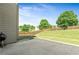 Concrete back patio with grill, overlooking a sloping, fenced yard at 532 Pelham Pl, Mcdonough, GA 30253
