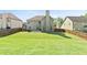 Large backyard with a well-maintained lawn, fenced perimeter, and patio area at 532 Pelham Pl, Mcdonough, GA 30253