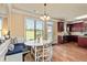 Cozy breakfast nook with built-in seating, a bright window, and a view of the kitchen and outdoor space at 532 Pelham Pl, Mcdonough, GA 30253