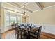 Elegant dining area with coffered ceilings, hardwood floors, and large windows offering abundant natural light at 532 Pelham Pl, Mcdonough, GA 30253