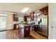 Well-equipped kitchen with stainless steel appliances, dark wood cabinets, and a central island, ideal for cooking at 532 Pelham Pl, Mcdonough, GA 30253