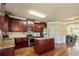 Spacious kitchen featuring dark wood cabinetry, granite countertops, and an island, connecting to the dining area at 532 Pelham Pl, Mcdonough, GA 30253