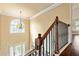 Upstairs landing with decorative railing and chandelier at 532 Pelham Pl, Mcdonough, GA 30253