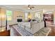 Comfortable living room featuring plush seating, a fireplace, and hardwood flooring at 532 Pelham Pl, Mcdonough, GA 30253