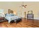 Large main bedroom showcasing hardwood floors, neutral paint, and a luxurious feel at 532 Pelham Pl, Mcdonough, GA 30253