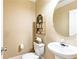 Cozy powder room featuring stylish fixtures, a round mirror, and decorative shelving at 532 Pelham Pl, Mcdonough, GA 30253
