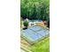 An aerial shot of community tennis courts and a pool surrounded by lush greenery at 532 Pelham Pl, Mcdonough, GA 30253