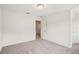 Bedroom with neutral walls and light gray carpet, featuring an open doorway at 5383 Heron Bay Blvd, Locust Grove, GA 30248