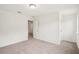 Bedroom with neutral walls and light gray carpet, featuring an open doorway at 5383 Heron Bay Blvd, Locust Grove, GA 30248