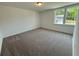 Bright bedroom with large windows offering natural light and a pleasant view at 5383 Heron Bay Blvd, Locust Grove, GA 30248
