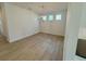 Dining room featuring laminate floors, chandelier and multiple windows at 5383 Heron Bay Blvd, Locust Grove, GA 30248