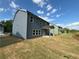 Back exterior showing a home with well-maintained landscaping and a welcoming covered patio at 5383 Heron Bay Blvd, Locust Grove, GA 30248