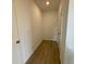Hallway and entrance featuring wood-look floors and a bright interior at 5383 Heron Bay Blvd, Locust Grove, GA 30248