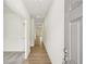 Inviting hallway featuring light wood floors and neutral walls that lead to other rooms at 5383 Heron Bay Blvd, Locust Grove, GA 30248