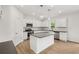 Modern kitchen featuring white cabinets, stainless steel appliances, and a center island at 5383 Heron Bay Blvd, Locust Grove, GA 30248