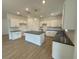 Modern kitchen featuring an island, white cabinets, and laminate flooring at 5383 Heron Bay Blvd, Locust Grove, GA 30248