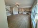 Open concept living room and kitchen area featuring plenty of natural light from several windows at 5383 Heron Bay Blvd, Locust Grove, GA 30248