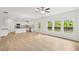 Spacious open-concept living room and kitchen with hardwood floors and bright windows at 5383 Heron Bay Blvd, Locust Grove, GA 30248