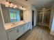 Beautiful bathroom with double sinks, a large mirror, glass door shower, and natural light at 5383 Heron Bay Blvd, Locust Grove, GA 30248