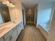 Modern primary bathroom featuring double sinks, separate shower, and luxurious soaking tub at 5383 Heron Bay Blvd, Locust Grove, GA 30248