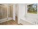 Beautiful bathroom featuring a large soaking tub and separate glass enclosed shower at 5383 Heron Bay Blvd, Locust Grove, GA 30248