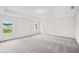 Spacious primary bedroom with plush carpet and large windows at 5383 Heron Bay Blvd, Locust Grove, GA 30248