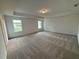 Spacious bedroom with carpet and natural light from large windows, creating a peaceful retreat at 5383 Heron Bay Blvd, Locust Grove, GA 30248