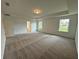 Large main bedroom with carpet, tray ceiling and natural light from several windows at 5383 Heron Bay Blvd, Locust Grove, GA 30248