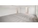 Spacious main bedroom featuring neutral carpeting, and doorway to the main bath at 5383 Heron Bay Blvd, Locust Grove, GA 30248