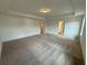 Bright and spacious main bedroom with carpet, natural light and ensuite bathroom entrance at 5383 Heron Bay Blvd, Locust Grove, GA 30248