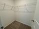 A practical walk-in closet is equipped with shelving for optimal storage and organization at 5383 Heron Bay Blvd, Locust Grove, GA 30248