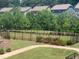 Well-maintained backyard features a black metal fence surrounding a grassy play area, ideal for recreation and relaxation at 613 Harrington Hls, Decatur, GA 30032