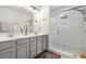 Modern bathroom with double vanity, subway tile shower, glass door, and decorative rug at 613 Harrington Hls, Decatur, GA 30032