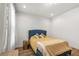 Cozy bedroom featuring a blue bed frame, soft yellow linens, and hardwood floors at 613 Harrington Hls, Decatur, GA 30032
