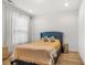 Bright bedroom with hardwood floors, a blue upholstered bed, and neutral decor at 613 Harrington Hls, Decatur, GA 30032
