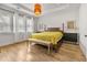 Sunlit bedroom featuring hardwood floors, a king bed, and modern decor with lots of natural light at 613 Harrington Hls, Decatur, GA 30032