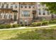 Attractive brick townhome exterior with well-maintained landscaping and inviting entrances at 613 Harrington Hls, Decatur, GA 30032