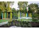 Striking modern home boasts colorful accents and a lush, landscaped yard surrounded by mature trees at 613 Harrington Hls, Decatur, GA 30032