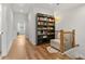 Open upstairs hallway with hardwood floors, a bookcase, and a reading nook near the stairs at 613 Harrington Hls, Decatur, GA 30032